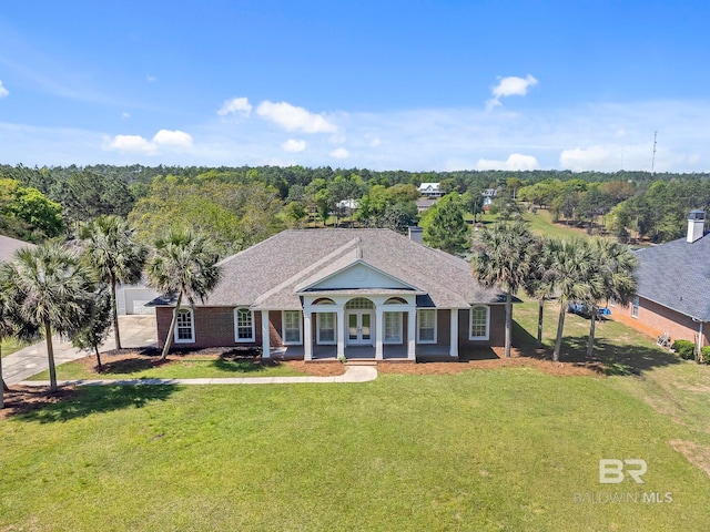 view of front of home featuring a shingled roof, french doors, and a front yard