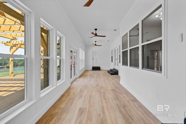 unfurnished sunroom with a water view