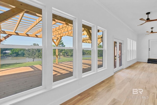 unfurnished sunroom featuring a water view, french doors, and a healthy amount of sunlight