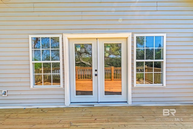 entrance to property featuring a wooden deck and french doors