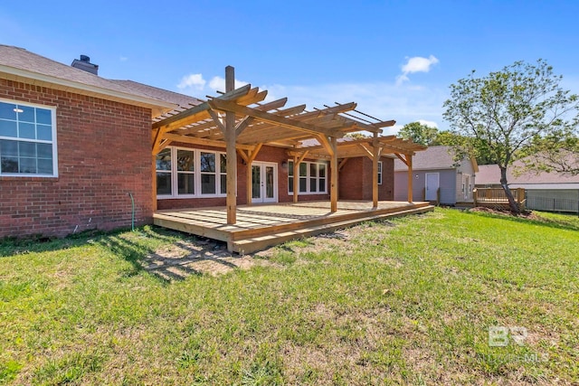 back of house with a wooden deck, french doors, brick siding, a pergola, and a yard