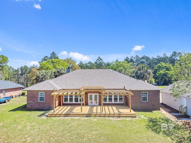 rear view of property featuring a pergola, french doors, a deck, and brick siding