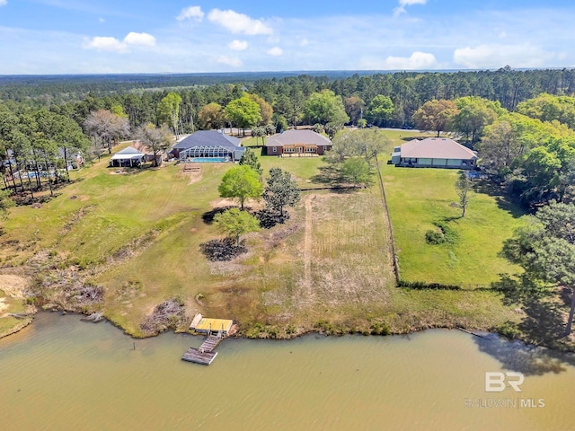 aerial view with a water view and a forest view