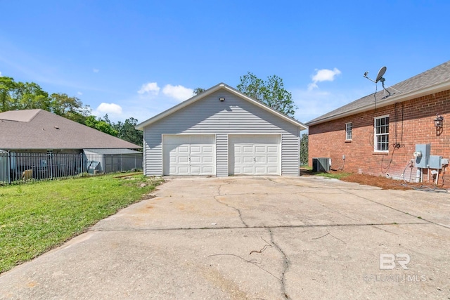 detached garage featuring central AC unit and fence