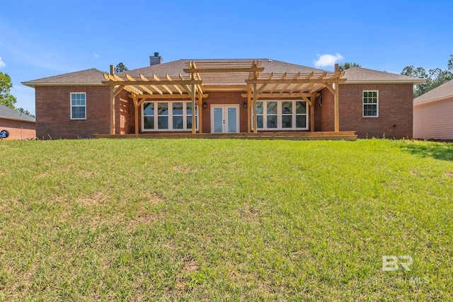 back of house with a lawn, brick siding, french doors, and a pergola