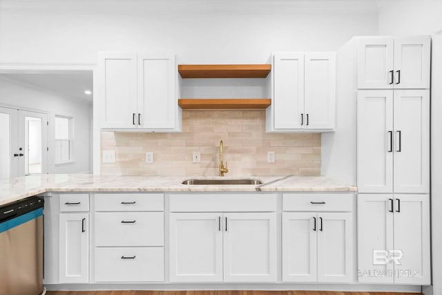 kitchen featuring a sink, open shelves, light stone countertops, dishwasher, and white cabinets
