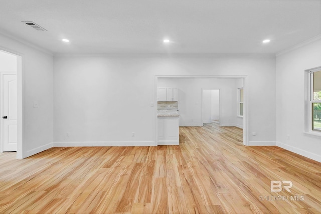 empty room with baseboards, visible vents, light wood-style floors, and recessed lighting
