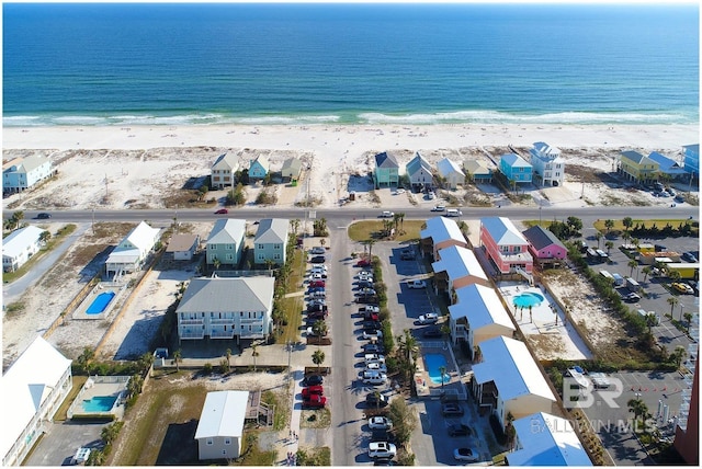 drone / aerial view featuring a water view and a view of the beach