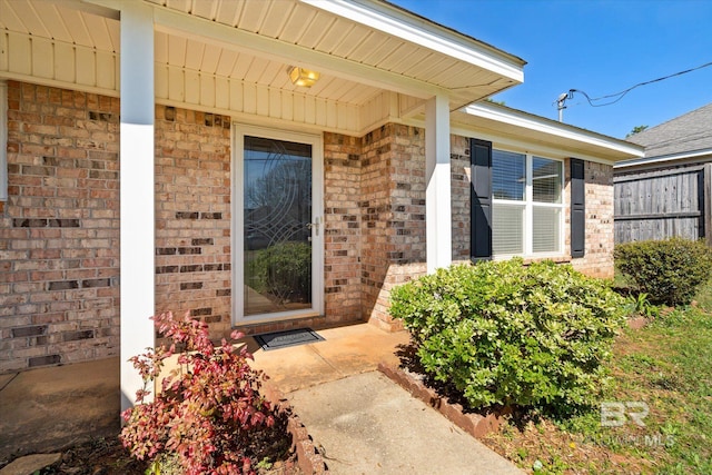 property entrance with brick siding