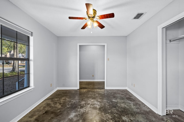 unfurnished bedroom featuring a textured ceiling, ceiling fan, and a closet