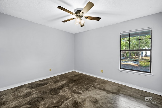 empty room featuring a textured ceiling, ceiling fan, and a healthy amount of sunlight