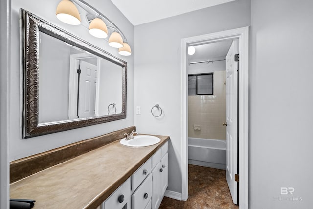 bathroom with tiled shower / bath combo and vanity