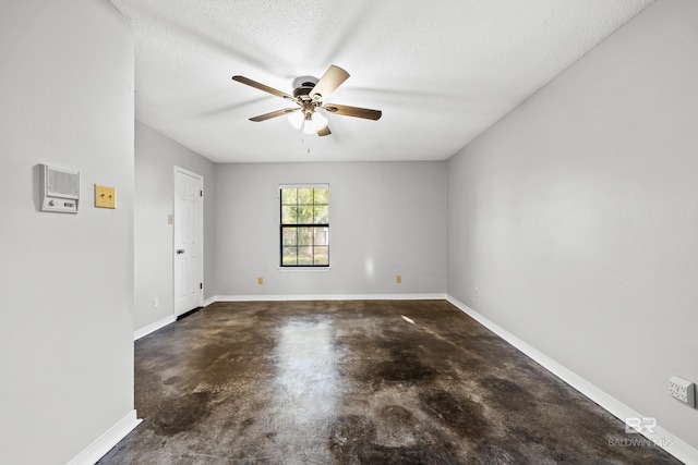 empty room with a textured ceiling and ceiling fan