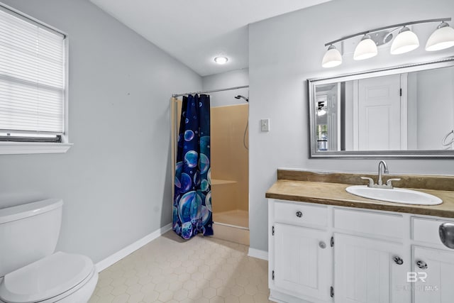 bathroom featuring toilet, a shower with shower curtain, and vanity