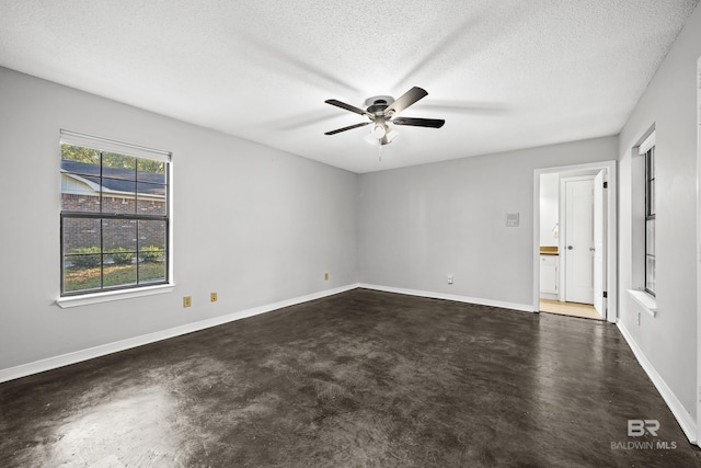 spare room featuring ceiling fan and a textured ceiling