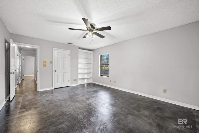 unfurnished bedroom with ceiling fan and a textured ceiling