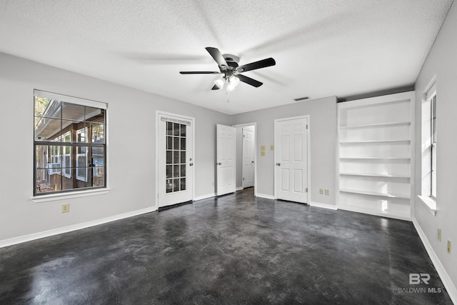 unfurnished bedroom featuring ceiling fan and a textured ceiling