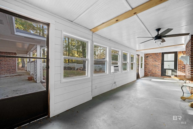 unfurnished sunroom featuring ceiling fan