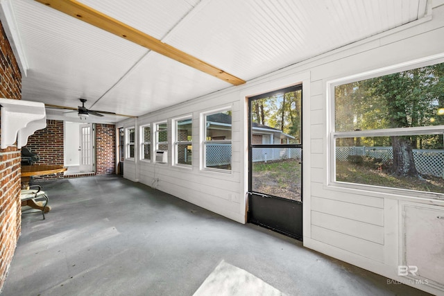 unfurnished sunroom with ceiling fan