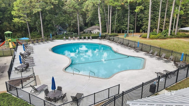 view of pool with a playground and a patio area