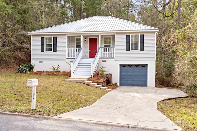 view of front of house with a garage, a front lawn, and covered porch