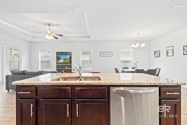 kitchen featuring dishwasher, light wood-type flooring, ceiling fan with notable chandelier, sink, and a raised ceiling