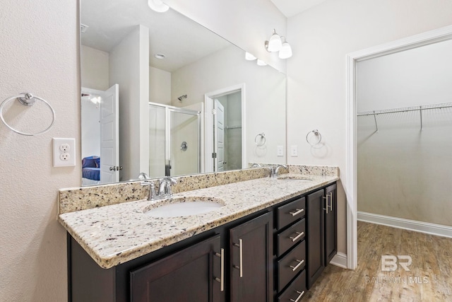 bathroom featuring vanity, hardwood / wood-style floors, and walk in shower