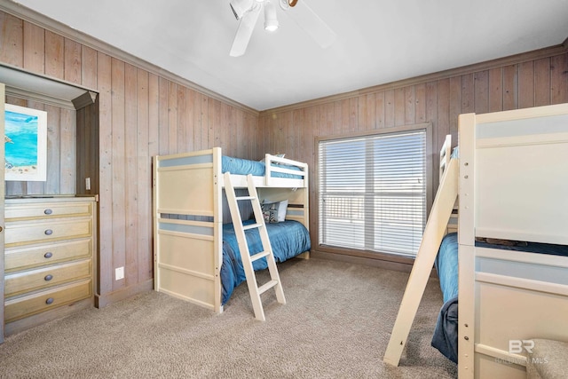 unfurnished bedroom with light carpet, ornamental molding, ceiling fan, and wood walls