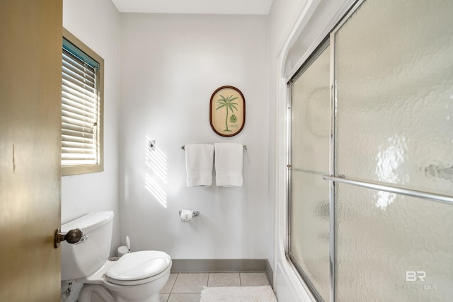 bathroom with walk in shower, tile patterned floors, and toilet