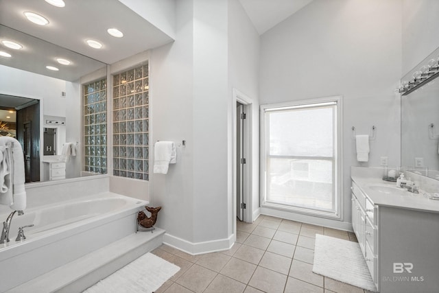 bathroom with tile patterned floors, vanity, and a washtub