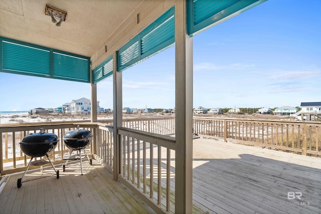 wooden deck with a grill
