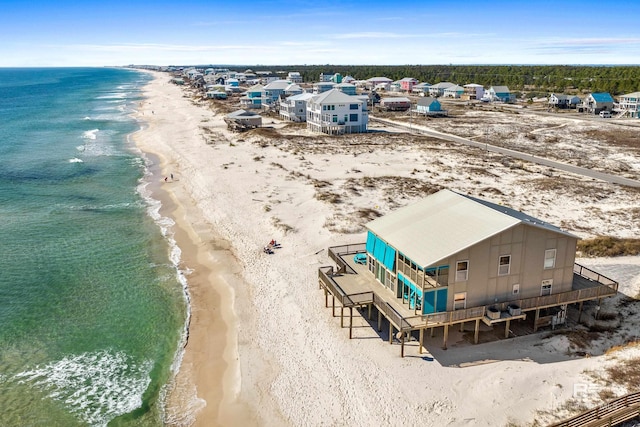 birds eye view of property with a water view and a beach view