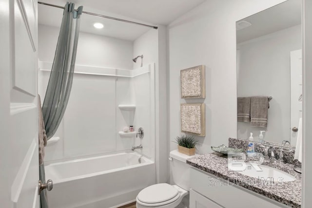 bathroom with toilet, vanity, and bathtub / shower combination