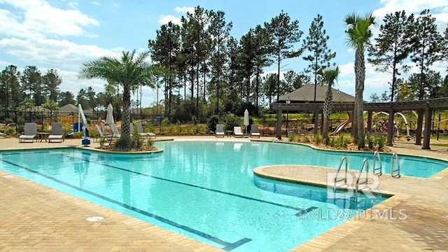 community pool with a gazebo, a patio, and fence