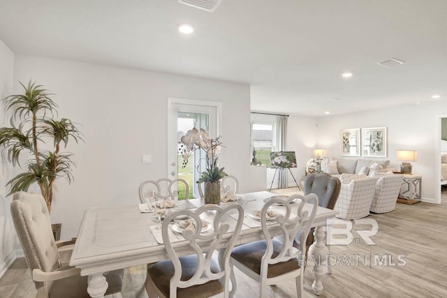 dining area featuring light wood-style flooring, recessed lighting, and baseboards