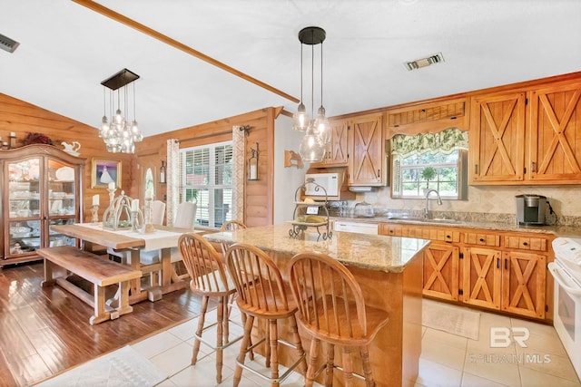 196 Jernigan Rd, Brewton, AL 36426 - kitchen with a sink, white appliances, wood walls, light stone counters, and decorative backsplash