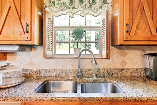 196 Jernigan Rd, Brewton, AL 36426 - kitchen featuring a sink, decorative backsplash, and light stone countertops