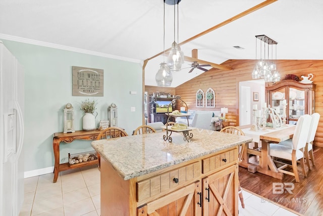 196 Jernigan Rd, Brewton, AL 36426 - kitchen with ceiling fan, light tile patterned floors, decorative light fixtures, light stone countertops, and lofted ceiling
