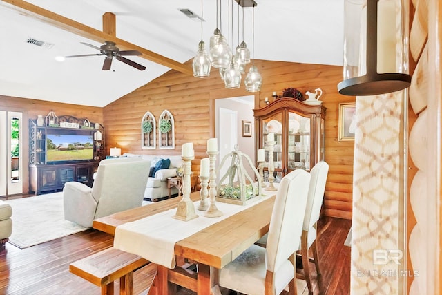 196 Jernigan Rd, Brewton, AL 36426 - dining room featuring log walls, wood finished floors, beamed ceiling, a ceiling fan, and high vaulted ceiling