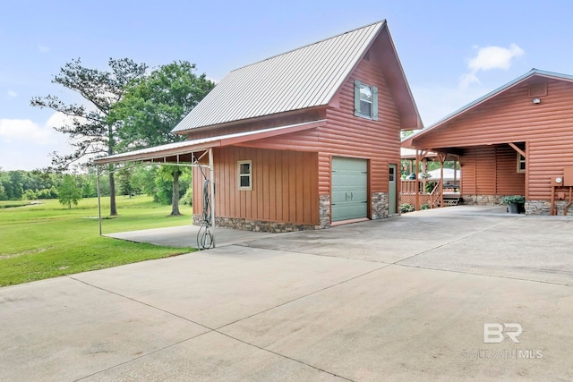 196 Jernigan Rd, Brewton, AL 36426 - view of home's exterior featuring a garage, a yard, driveway, metal roof, and an outbuilding