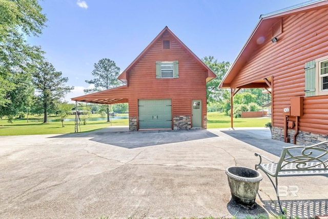 196 Jernigan Rd, Brewton, AL 36426 - view of side of home featuring a yard, driveway, stone siding, and an attached garage