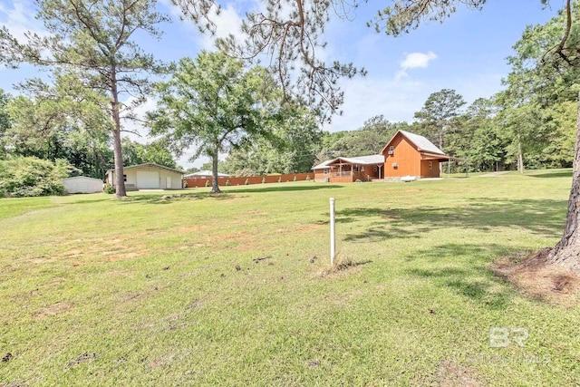 196 Jernigan Rd, Brewton, AL 36426 - view of green lawn with a garage and an outdoor structure