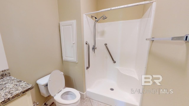 bathroom featuring walk in shower, tile patterned floors, vanity, and toilet