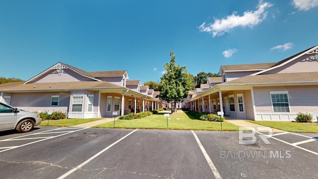 view of parking / parking lot featuring a yard