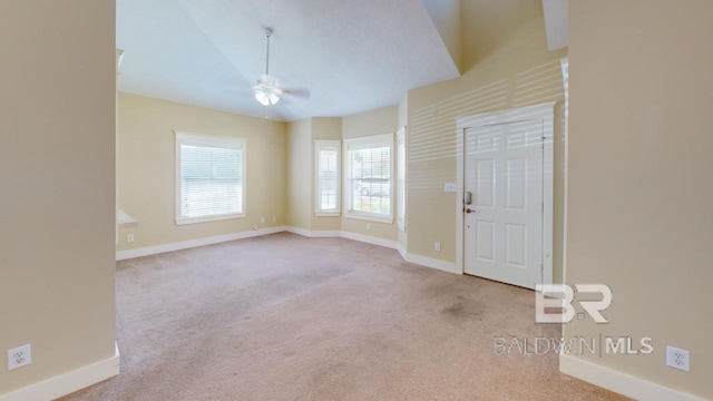 carpeted spare room with ceiling fan