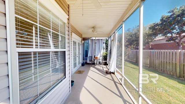 unfurnished sunroom with a healthy amount of sunlight and ceiling fan