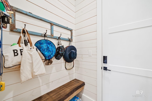 mudroom with wooden walls