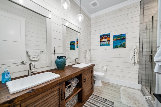 full bathroom featuring toilet, a shower stall, visible vents, and a sink