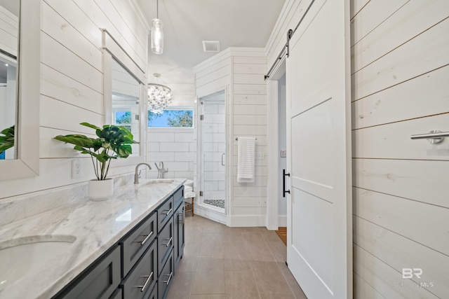 bathroom with wood walls, a sink, a shower stall, and double vanity