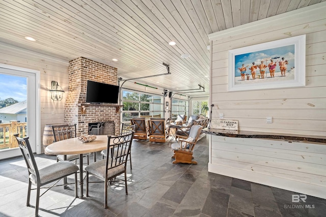 view of patio featuring outdoor dining space and a fireplace